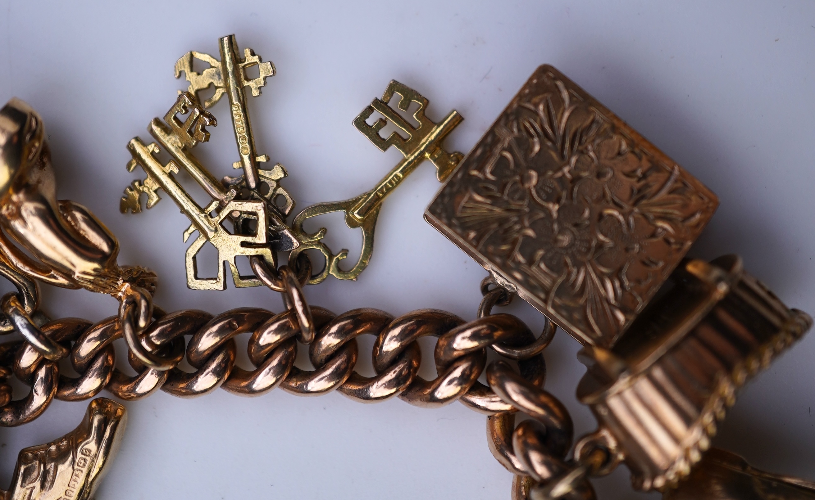 A 9ct gold charm bracelet, mid 20th century